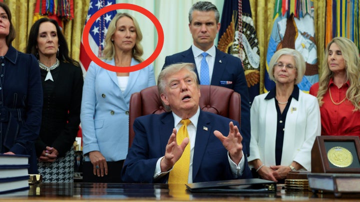 Jennifer Hegseth stands behind the president and beside her husband in the Oval Office during a executive order ceremony establishing the President’s Military Spouse Commission in which Jennifer Hegseth serves as chairwoman.
