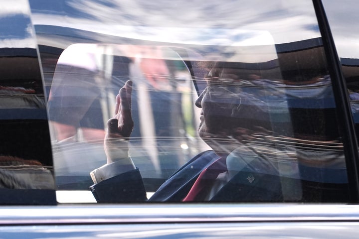 Donald Trump, in the presidential limousine known as "The Beast," waves to racing fans as he does a lap around the track before the IndyCar Freedom 250 Grand Prix in Washington, D.C. on Sunday. (AP Photo/Alex Brandon)