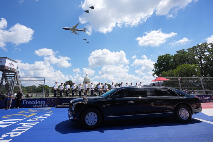 Air Force One and four F-35's pass overhead as Donald Trump, in the presidential limousine known as "The Beast," does a lap around the track before the IndyCar Freedom 250 Grand Prix on Sunday. (AP Photo/Alex Brandon)