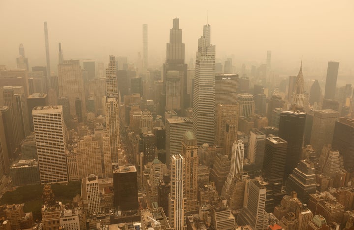Smoke from wildfires in Canada shrouds the view north to midtown Manhattan, seen from the 86th floor observation deck of the Empire State Building before sunset on July 15, 2026, in New York City.