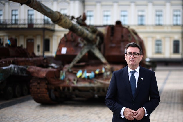 Britain's Prime Minister Andy Burnham stands by destroyed Russian vehicles displayed at Mykhailivska Square (St Michael's Square) in the old part of Kyiv, Monday, Aug. 24, 2026.