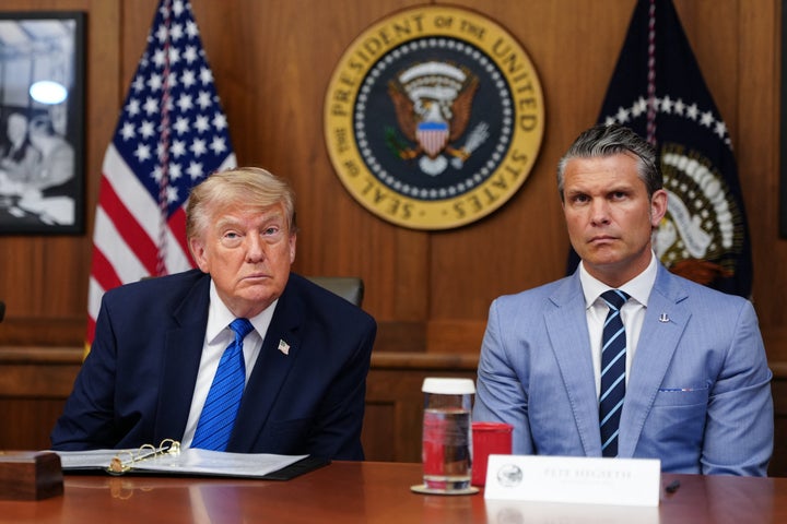 Donald Trump and Pete Hegseth listen to questions from the press during a Cabinet meeting at Camp David on July 31.
