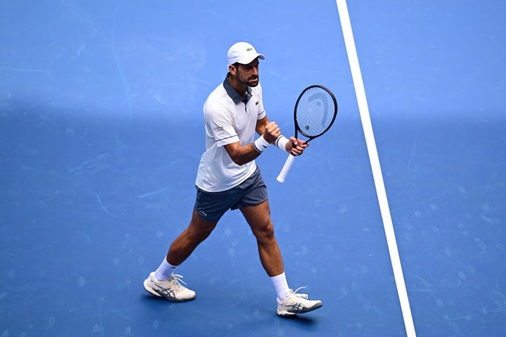 Novak Djokovic pumps his fist during a mixed doubles match on Tuesday. (Photo by Mike Lawrence/USTA via Getty Images)