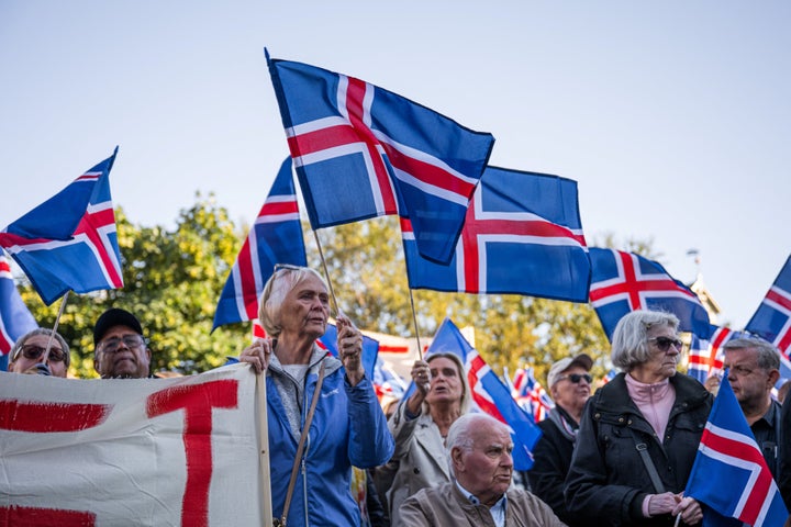 Supporters of the 'No' campaign wave Icelandic flags during a rally against reopening Iceland's European Union accession negotiations in Reykjavik, Iceland, on August 27, 2026, two days ahead of a national referendum. (Photo by Jonathan NACKSTRAND / AFP via Getty Images)