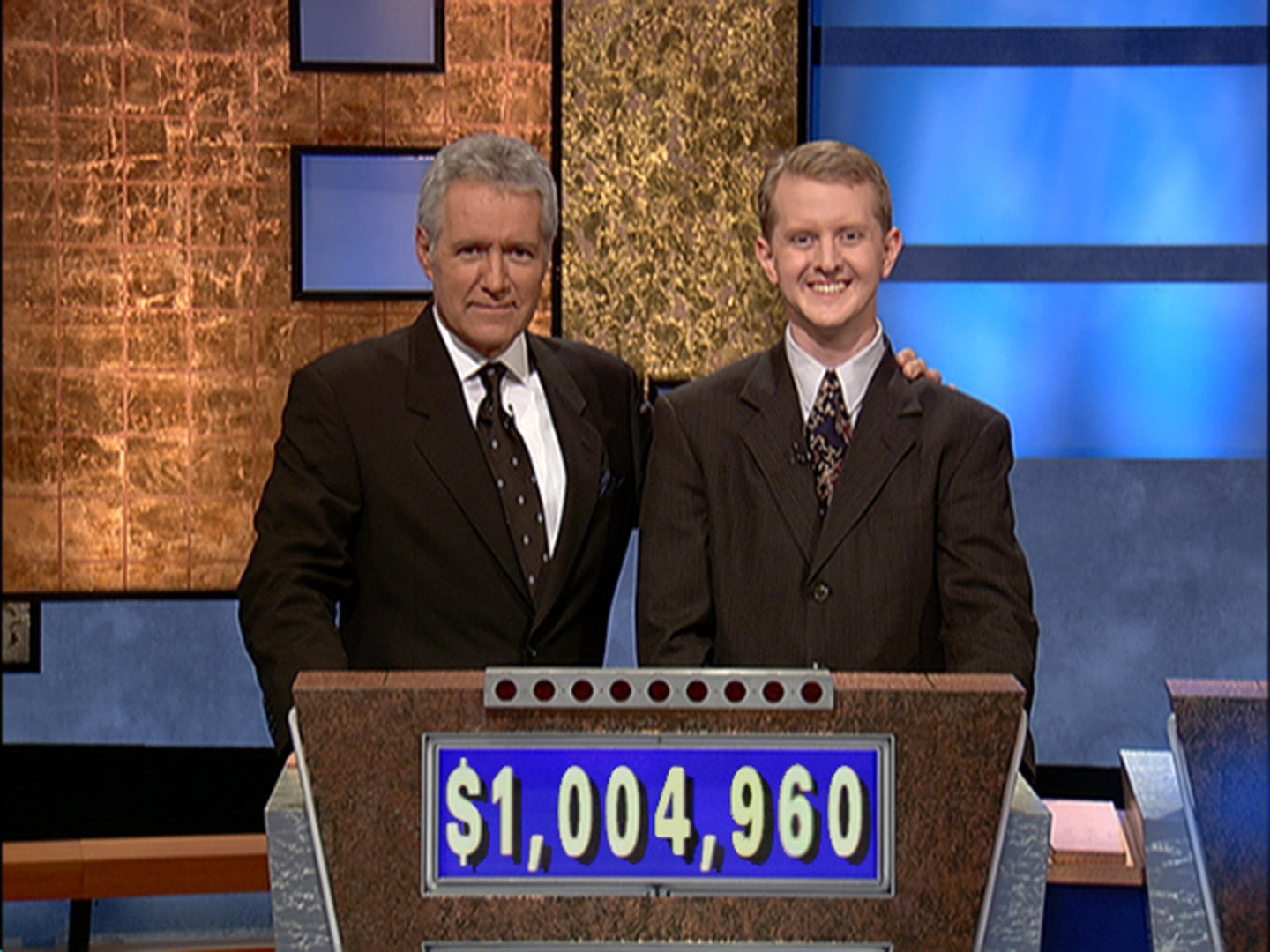 “Jeopardy!” host Alex Trebek poses with contestant Ken Jennings after earnings from his record-breaking streak surpassed