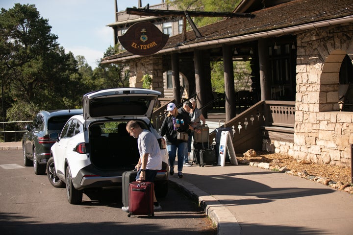 Tourists check out of the El Tovar Hotel after lodging along the rim of the Grand Canyon was shut down due to flooding.