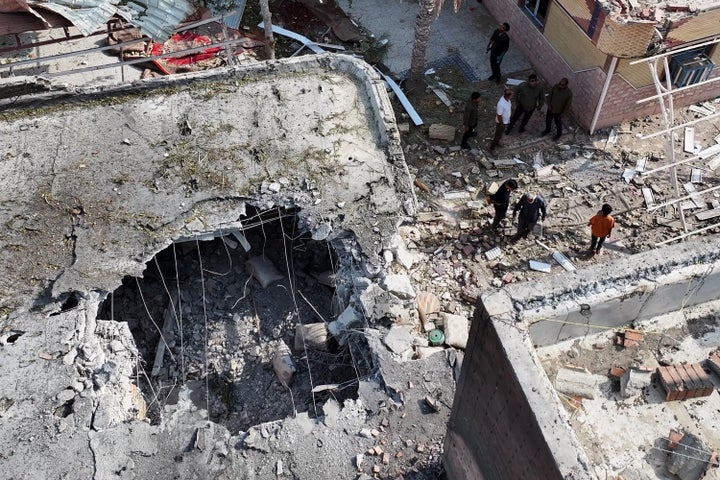 People inspect damage and debris at a building that Iranian media said was hit by a U.S. strike while a wedding celebration was taking place there, in Kuhestak, southern Iran, Wednesday, Sept. 2, 2026. (Morteza Akhoondi/Tasnim News Agency via AP)