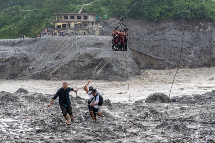 Residents pull a newly installed zipline to help people commute across the Trishuli river in the aftermath of flash floods at Bidur in Nepal's Nuwakot district, Nepal, on Sept. 2, 2026.