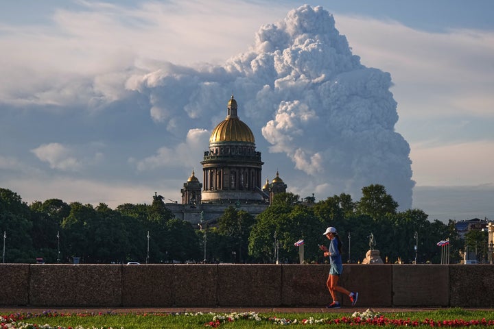 Smoke rises after a Ukrainian drone strikes on warehouses of the online retailer Wildberries in St. Petersburg, Russia, on July 24, 2026, with St. Isaac's Cathedral in foreground.