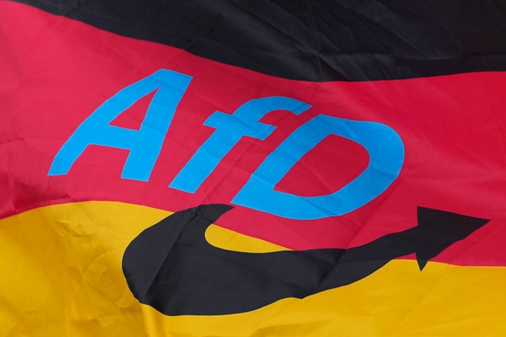 The logo of the "Alternative for Germany" (AfD) party is fixed on a German national flag for the state elections in Saxony-Anhalt during an election campaign event in Magdeburg, Germany, Friday, Sept. 4, 2026.