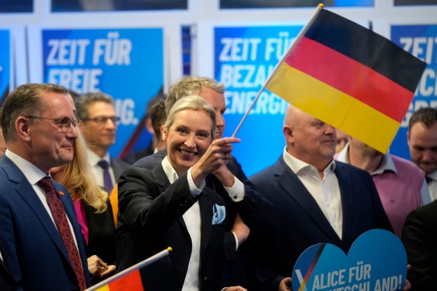 Leader of far right AfD Alice Weidel waves a German flag at the AfD party headquarters in Berlin, Germany, Sunday, Feb. 23, 2025, after the German national election.