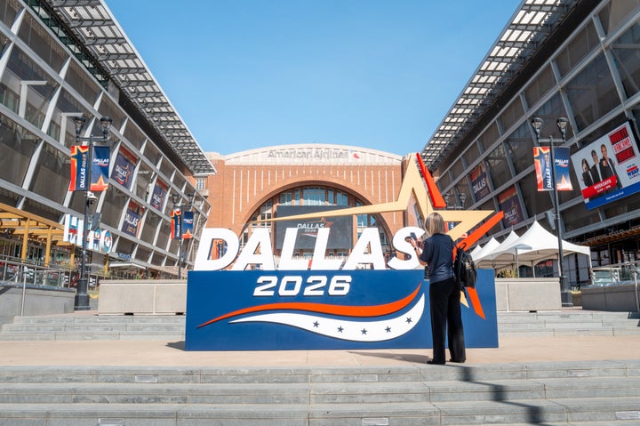 A person takes pictures of signage during preparation for the Republican National Committee (RNC) Midterm Convention at the American Airlines Center on Sept. 7, 2026 in Dallas, Texas.