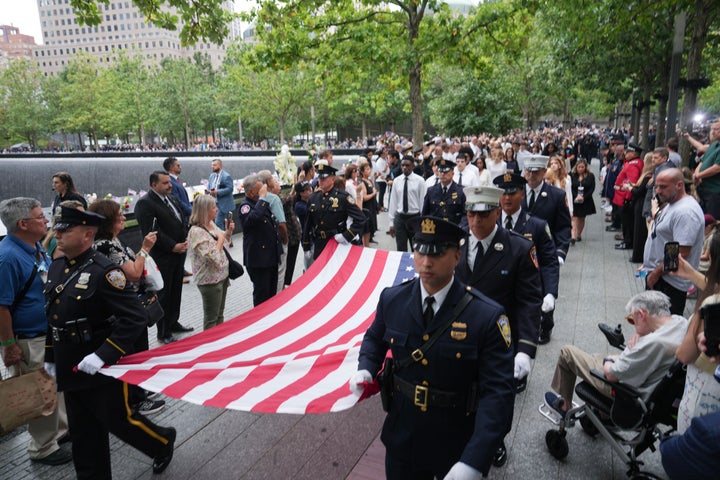 NYPD and NYFD officers carry a U.S. flag during a memorial ceremony to commemorate the 25th anniversary of the September 11th terrorist attacks on the World Trade Center at the National 9/11 Memorial & Museum on September 11, 2026, in New York City. (Photo by David Dee Delgado - Pool/Getty Images)