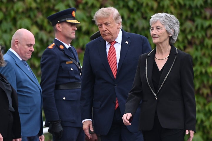 U.S. President Donald Trump walks across the manicured lawns alongside Irish President Catherine Connolly during the ceremonial arrival events at Aras an Uachtarain on September 12, 2026, in Dublin, Ireland. (Photo by Artur Widak/Anadolu via Getty Images)
