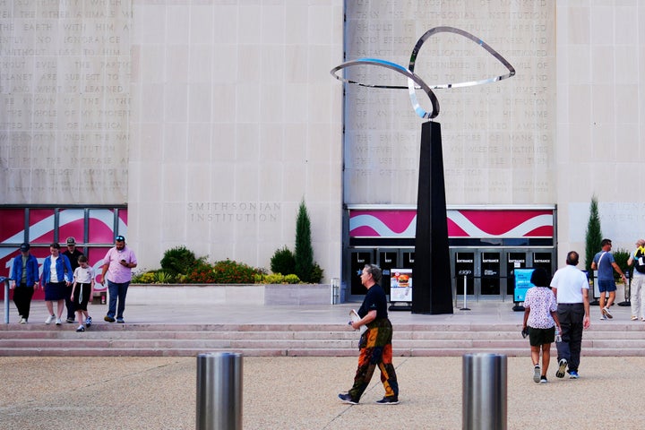 People walking past the "Infinity" sculpture outside the Smithsonian National Museum of American History on the National Mall in Washington, Tuesday, Sept. 8, 2026. (AP Photo/Pablo Martinez Monsivais)