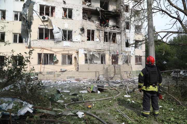 Firefighters and emergency personnel work on the scene of damaged multi-story residential buildings, warehouses and utility structures following Russian strikes on Odesa and the surrounding region in Ukraine on Sept. 13, 2026.