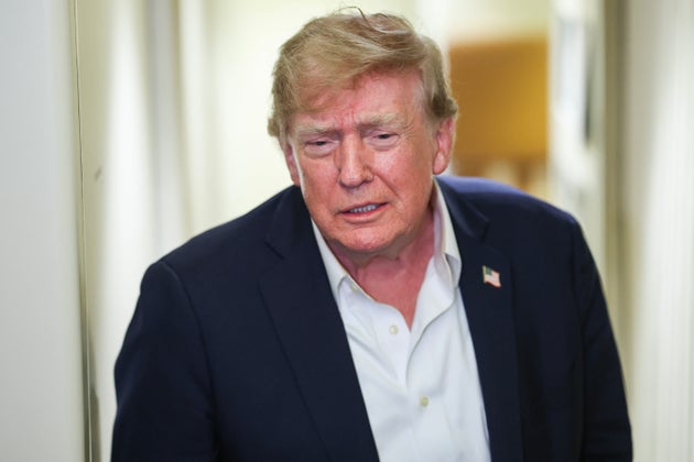 President Donald Trump speaks to reporters aboard Air Force One while traveling back from Ireland to Joint Base Andrews, Maryland, on Sept. 13 in flight.