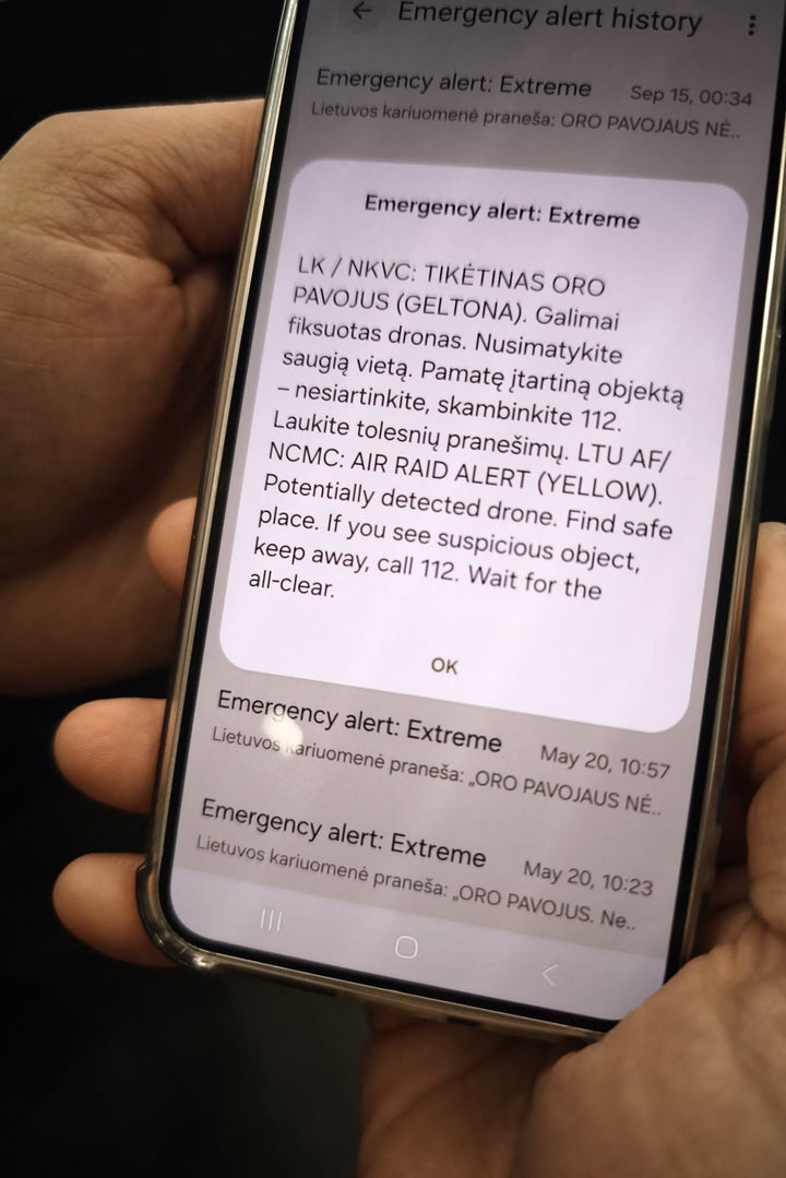 A phone displays the alert message sent to the public, warning about a possible drone attack in Vilnius on Sept. 15, 2026. NATO fighter jets shot down a drone over Lithuania, the president of the Atlantic Alliance member country, Gitanas Nausda, announced.