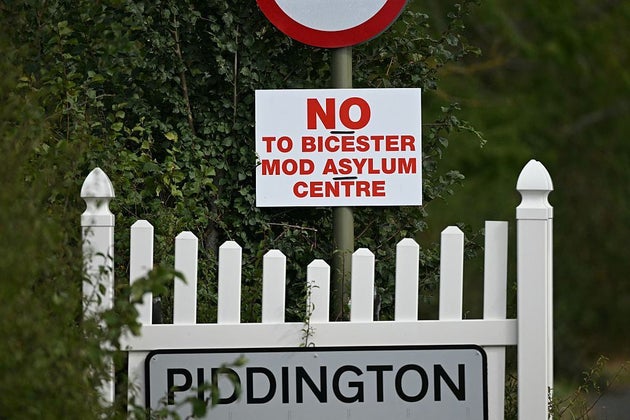 A sign for the village of Piddington next to another saying 'No to Bicester MOD asylum centre' 