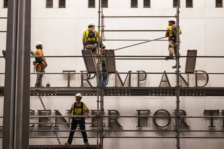 Workers put up scaffolding prior to the removal of Trump’s name from the Kennedy Center on June 12 in Washington, D.C.