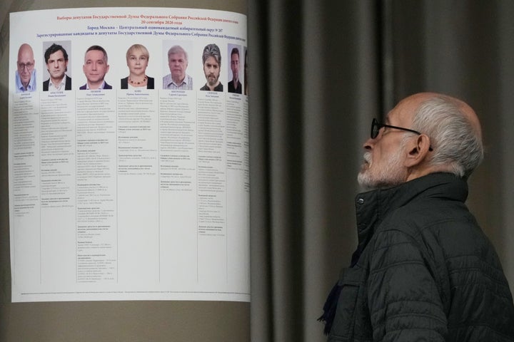 A voter examines a poster informing about the single-member district candidates in the parliamentary election in Moscow, on Sept. 20, 2026.