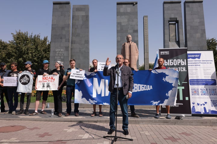 Russian citizens hold anti-war and anti-Putin posters as they line up outside the Russian Embassy to protest the ruling United Russia party and Moscow's ongoing invasion of Ukraine in Yerevan, Armenia, on Sept. 20, 2026, during the final day of Russia's parliamentary elections.