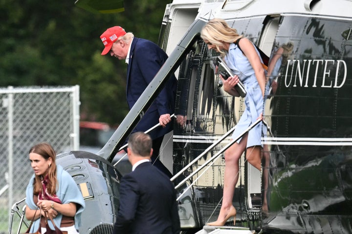 President Donald Trump and aide Natalie Harp exit Marine One on the Ellipse near the White House on Aug. 16 after a weekend at his golf club in New Jersey.