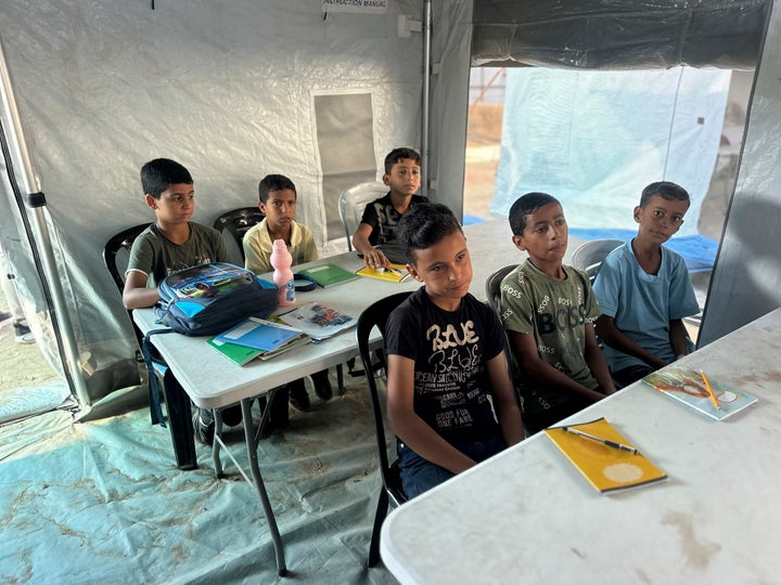 Palestinian students sit at desks inside a tent at the Shafa Amr school in the Al-Mawasi area of Khan Yunis, Gaza Strip, on September 19.