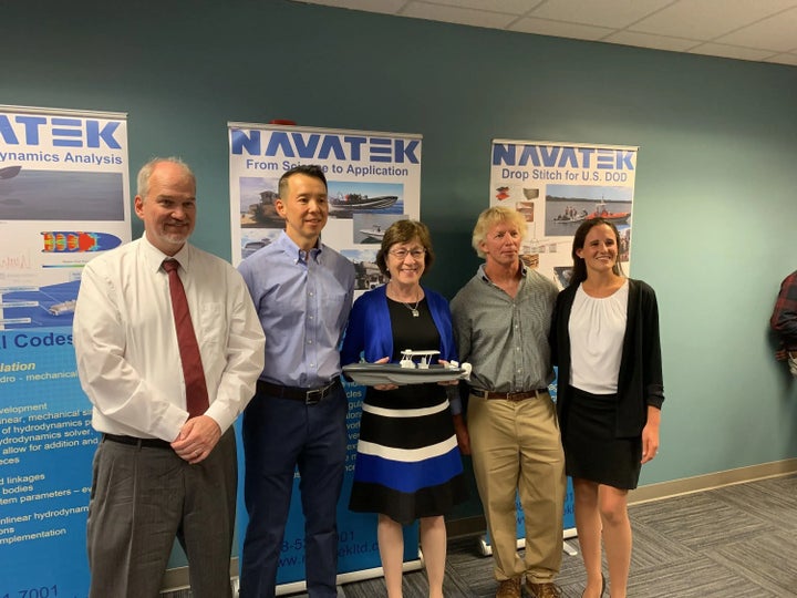 Martin Kao, second from left, with Collins, center, at a publicity event at Navatek’s Maine headquarters in August 2019.