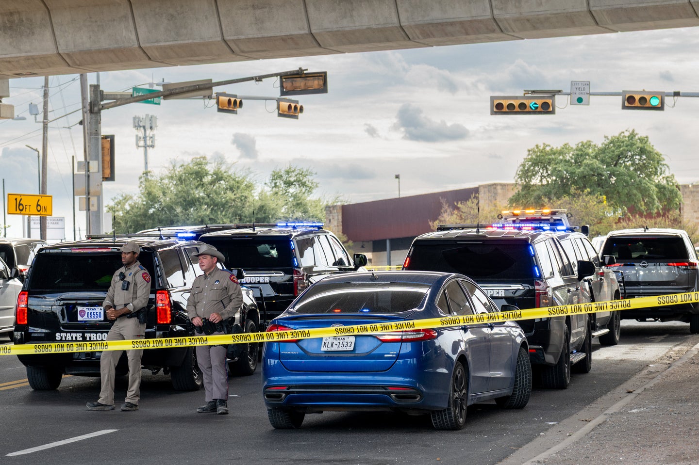 Law enforcement monitor a vehicle that was shot at by Immigration and Customs Enforcement officers on Sept. 20 in Austin, Texas.