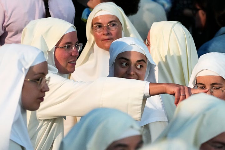 Nuns wait for the arrival of Pope Leo XIV for a prayer at the Grotto of the Apparitions of Massabielle, at the Shrine of Our Lady of Lourdes, Saturday, Sept. 26, 2026. (AP Photo/Gregorio Borgia)
