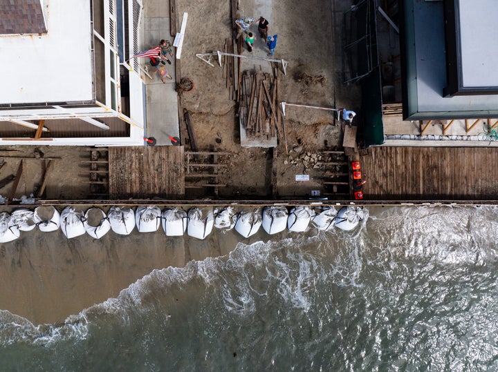 An aerial of onlookers watching the waves come over sandbags along the East Seaside Walk on Sept. 27, 2026 in Long Beach, California. A Hurricane Polo Public Advisory has been issued as dangerous winds and ocean conditions hit Mexico and Southern California.