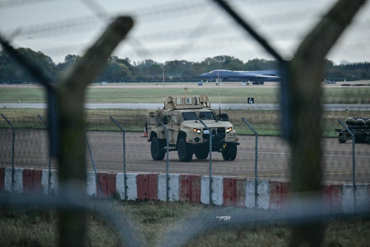 An armored vehicle (C) patrols the interior at RAF Fairford base in Fairford on Sept. 28, 2026, a day after British counter-terrorism police were probing "a major" incident near the base. Armed officers detained a group of five men in the early hours after a call to emergency services about three "suspicious vehicles which appeared to be traveling towards the air base", London's Metropolitan Police said in a statement.