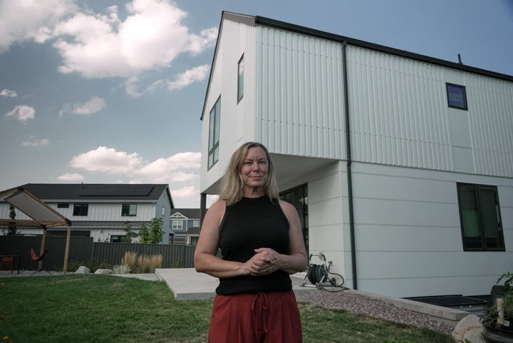 Tawnya Somauroo stands in front of her new fire-resilient home Monday, Sept. 21, 2026, in Louisville, Colo. (AP Photo/Brittany Peterson)