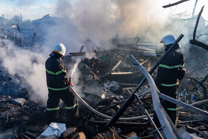 A rescue worker extinguishes a fire at a residential house destroyed by a Russian airstrike in Kharkiv, Ukraine, Friday, Oct. 2, 2026.(AP Photo/Andrii Marienko)