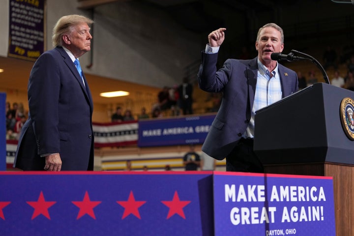 Sen. Jon Husted, R-Ohio, speaks as President Donald Trump listens during an event at Butler High School in Vandalia, Ohio, Saturday, Oct. 3, 2026. (AP Photo/Mark Schiefelbein)