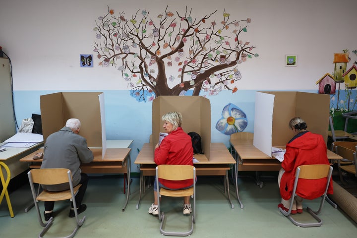 People cast their ballots during the general election in Sarajevo, Bosnia, Sunday, Oct. 4, 2026. (AP Photo/Armin Durgut)