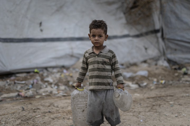 A boy carries empty bottles as Palestinian families displaced by Israel's relentless bombardment of the Gaza Strip struggle to survive in makeshift tents in Gaza City, Gaza, on Sept. 29, 2026. Civilians are unable to access basic humanitarian necessities such as food, clean water, medical supplies and shelter due to Israel's tight blockade.