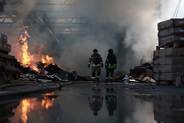 Rescue workers extinguish a fire at a furniture factory, damaged by a Russian drone strike, in Zaporizhzhia, Ukraine, Tuesday, Oct. 6, 2026. 