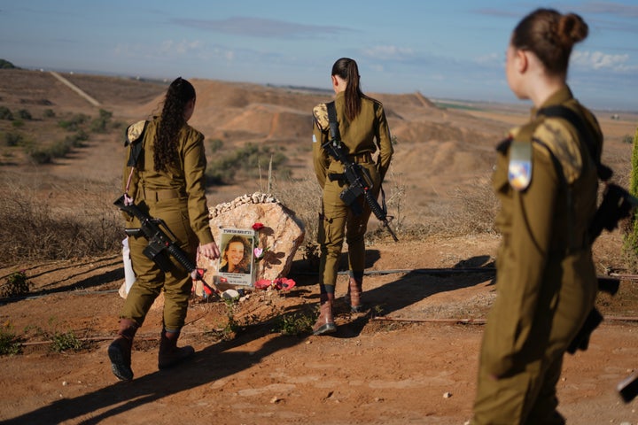 Israeli soldiers attend a memorial service marking the third anniversary of the Oct. 7, 2023, Hamas-led cross-border attack on Israel, near Kibbutz Nahal Oz, southern Israel, where female observer soldiers were killed, Wednesday, Oct. 7, 2026. (AP Photo/Ariel Schalit)