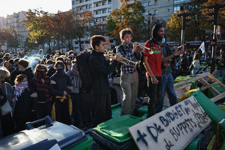Protesters including some playing the trumpet take part in a blockade action near Helene Boucher high-school during a demonstration of high-school students in Paris, on Oct. 8, 2026, as part of a nationwide protest movement over learning conditions. 