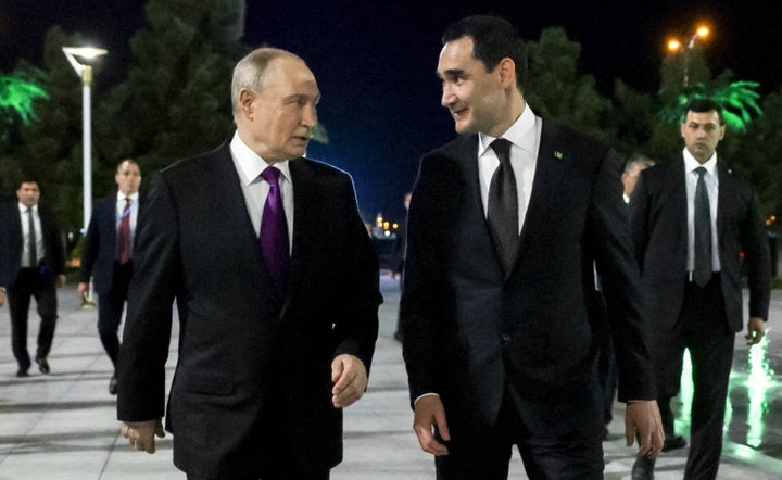 In this pool photograph distributed by the Russian state agency Sputnik, Russian President Vladimir Putin and Turkmen President Serdar Berdymukhamedov walk during a meeting in Turkmenbashi on October 8, 2026.