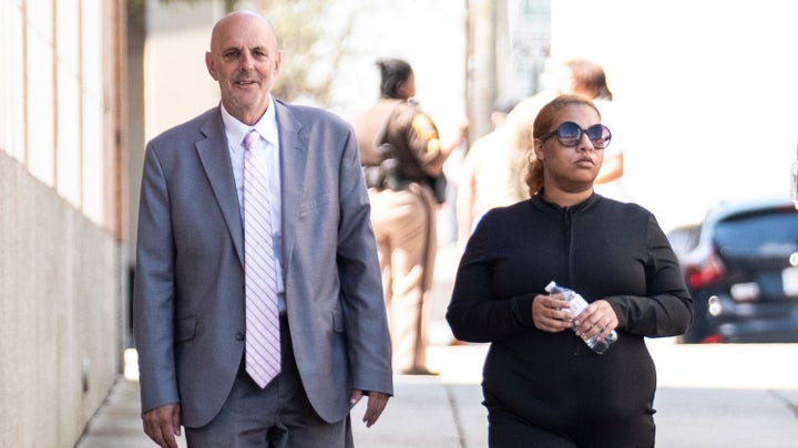 Deja Taylor, right, is seen with her attorney in Newport News, Virginia, on April 13, 2023, to turn herself in.