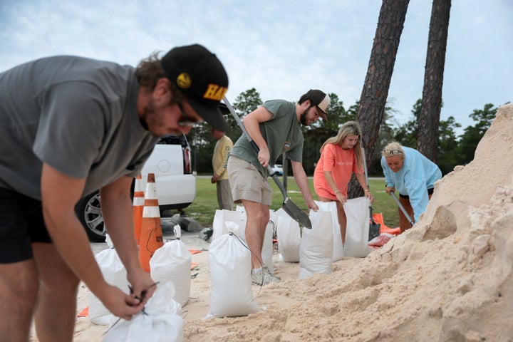 People fill sandbags that were provided by the city of Orange Beach as they prepare for the arrival of Hurricane Isaias on Thursday.