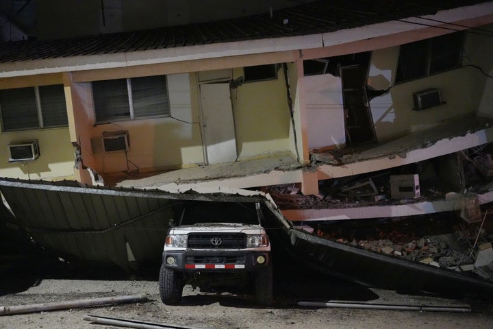 A vehicle lies crushed beneath a collapsed building after an earthquake struck Penonome, Panama, Friday, Oct. 9, 2026. (AP Photo/Aris Mariota)