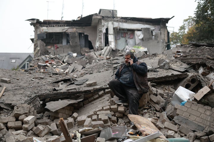 A man talks on the phone while sitting on the rubble of a residential building destroyed by a Russian airstrike in Zaporizhzhia, Ukraine, Saturday, Oct. 10, 2026. (AP Photo/Kateryna Klochko)