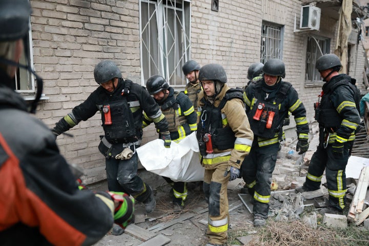 Rescue workers carry a body after pulling from the rubble of a residential building destroyed by a Russian airstrike in Zaporizhzhia, Ukraine, Saturday, Oct. 10, 2026. (AP Photo/Kateryna Klochko)