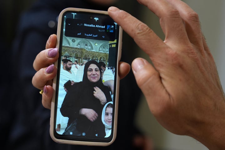 A portrait of Buthaina Ahmad Oweida, the Syrian woman who died in yesterday's attack on the Riyadh airport, is displayed on the mobile phone of her nephew at her family house, in her hometown of Hafasraja, Idlib province, Syria, Oct. 11, 2026. (AP Photo/Omar Albam)