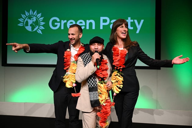 Green Party leader Zack Polanski (l), Mothin Ali, Deputy Leader of the Green Party and Rachel Millward, Deputy Leader of the Green Party react to the crowd after both of the deputy leader speeches on the second day of the Green Party Conference at Bournemouth International Centre at Bournemouth International Centre on October 04, 2025 