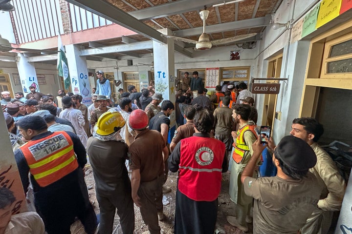 Rescue workers and volunteers take part in the rescue operation at the site of a roof collapse at a private school, in Peshawar, Pakistan, on Oct. 15, 2026.
